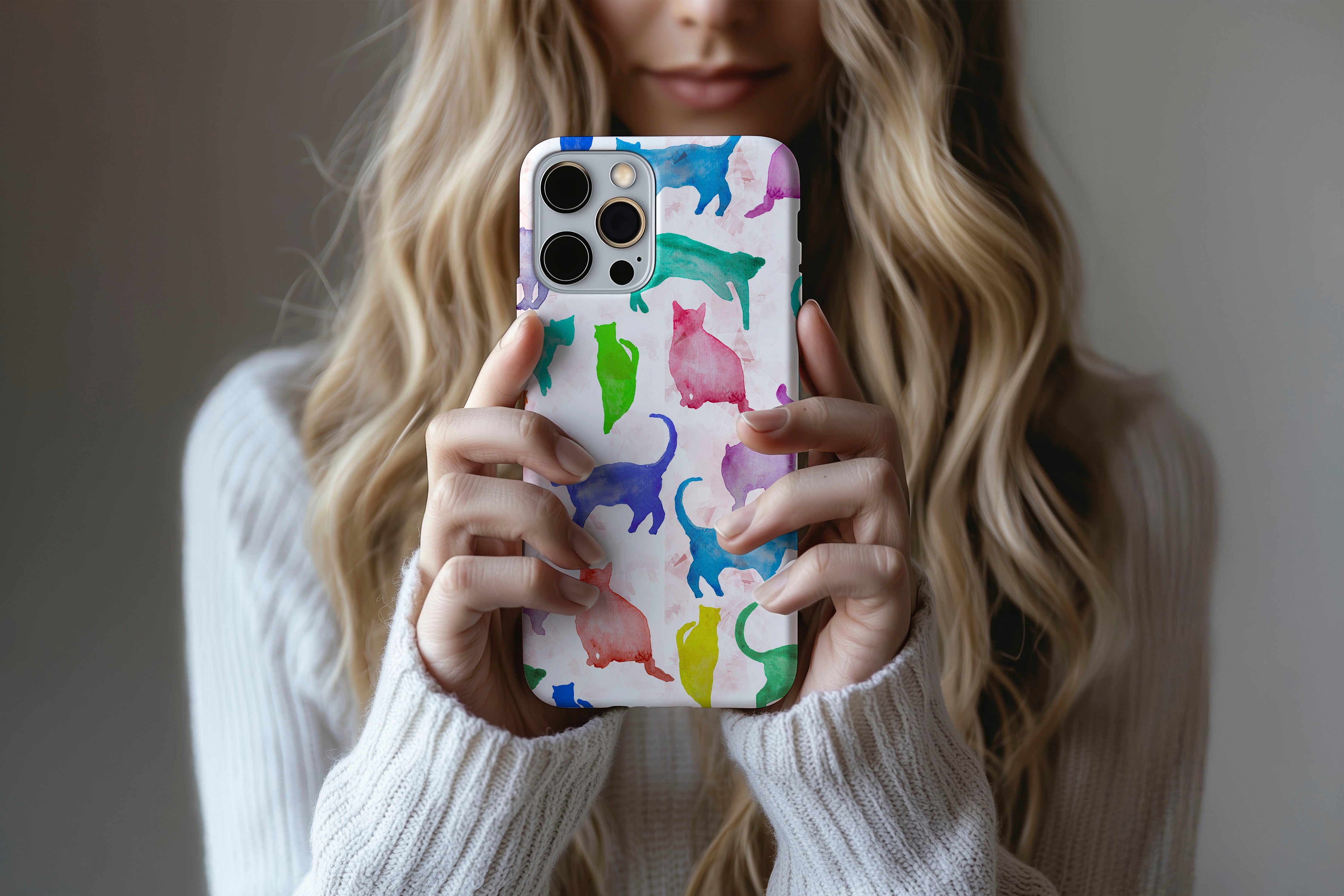 Lifestyle image of Abstract Cats phone case showing multi colour cat print design