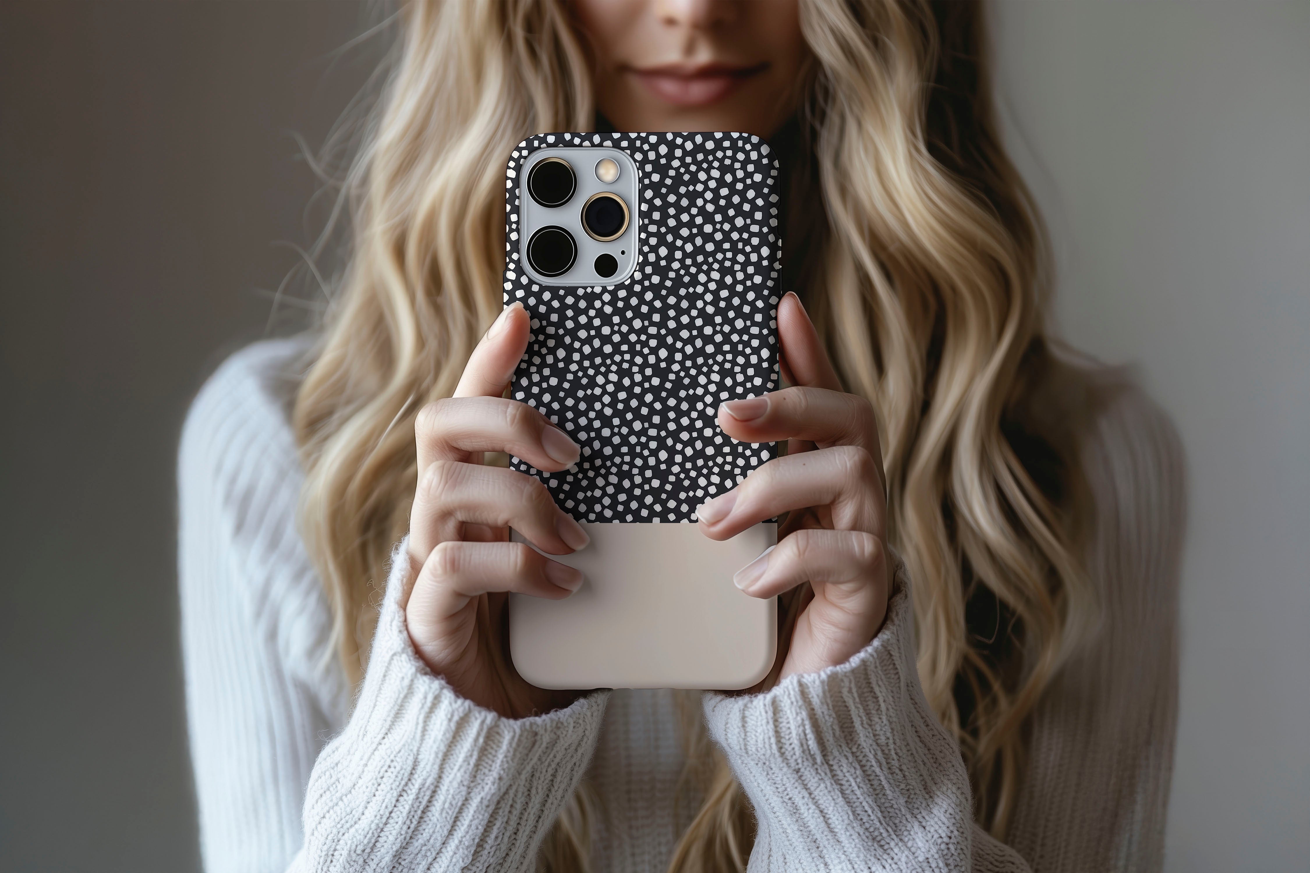 Lifestyle image of Black Spot phone case showing geometric design