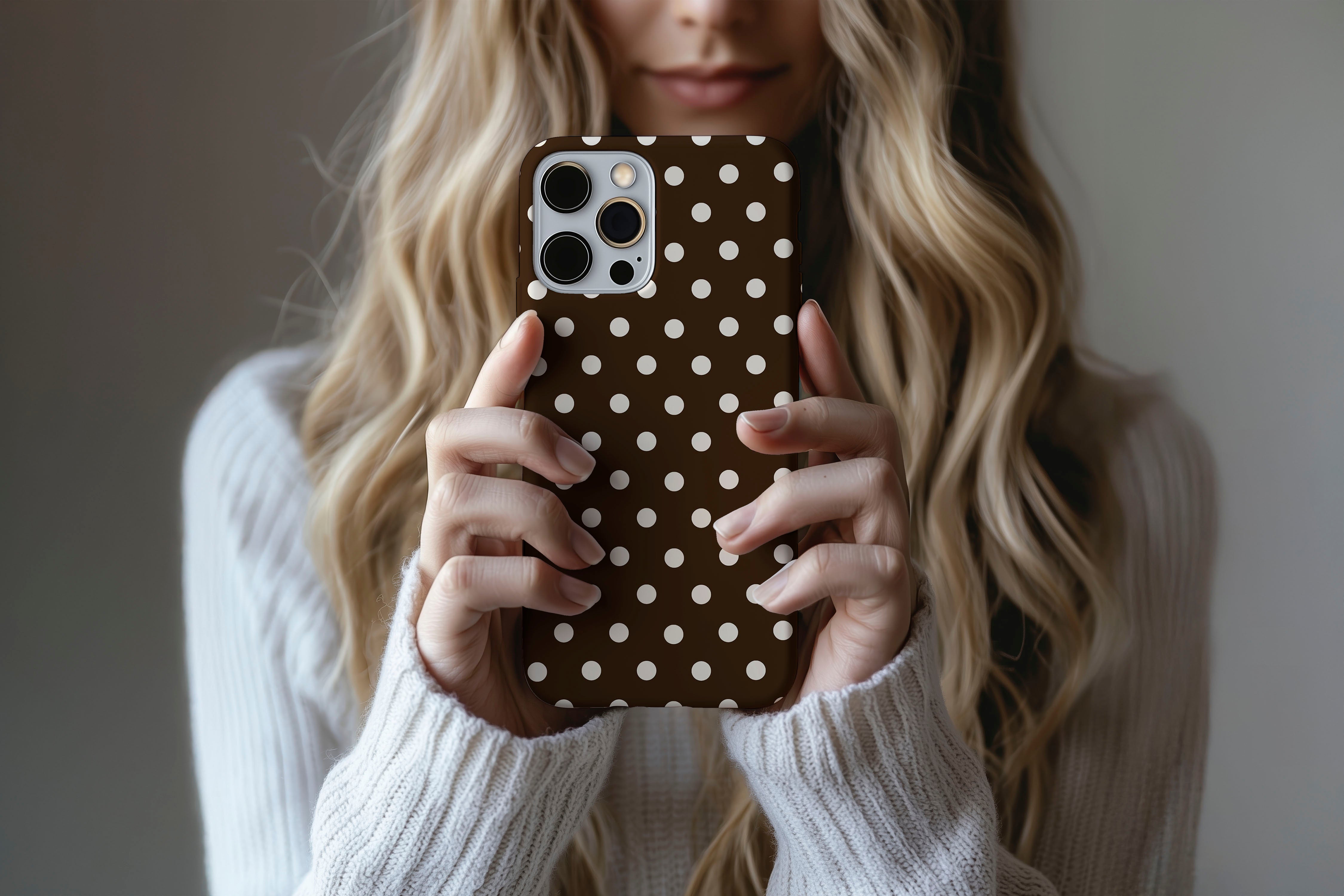 Lifestyle image of Chocolate Spot phone case showing spotty print design
