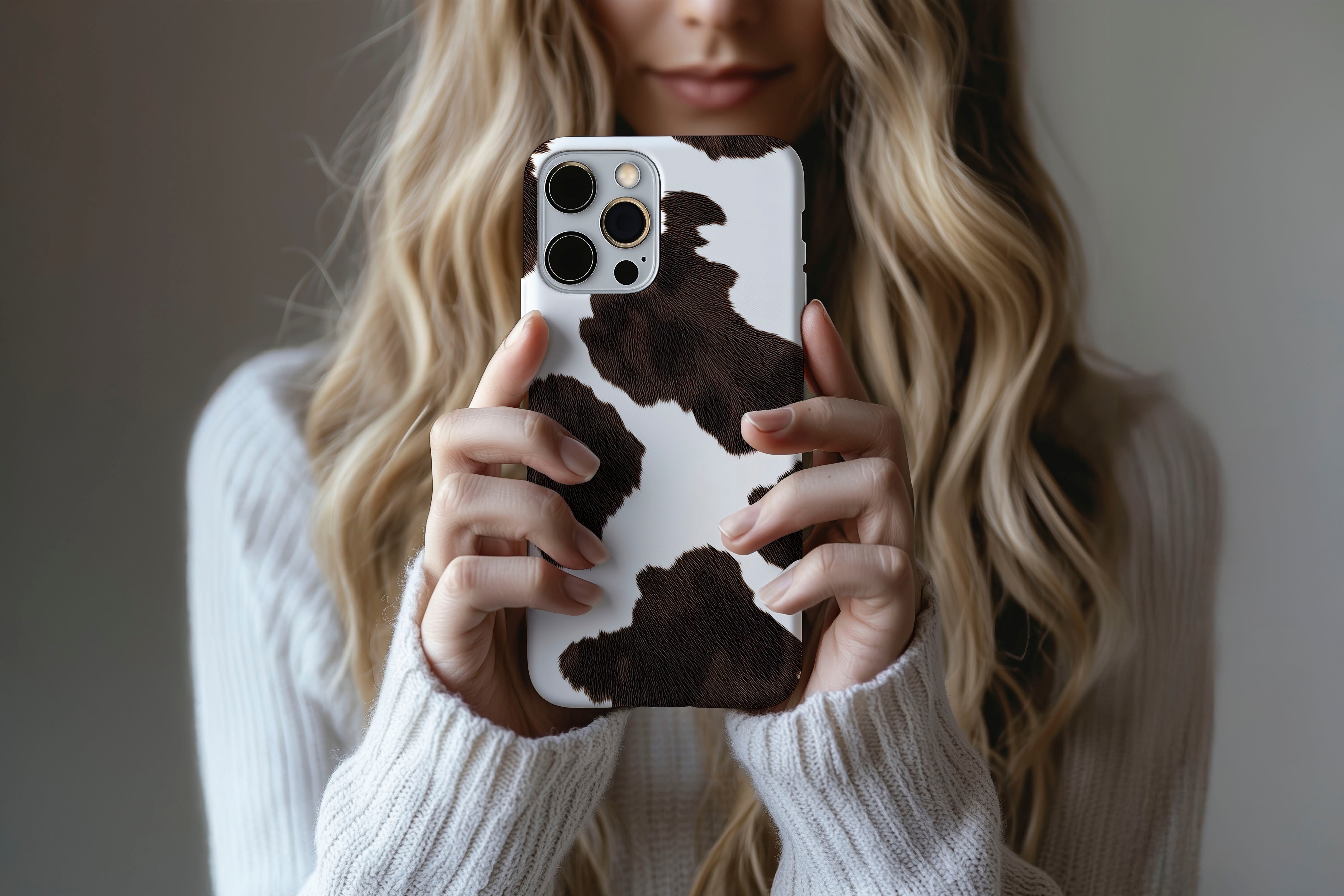 Lifestyle image of Cowhide phone case showing dotty design