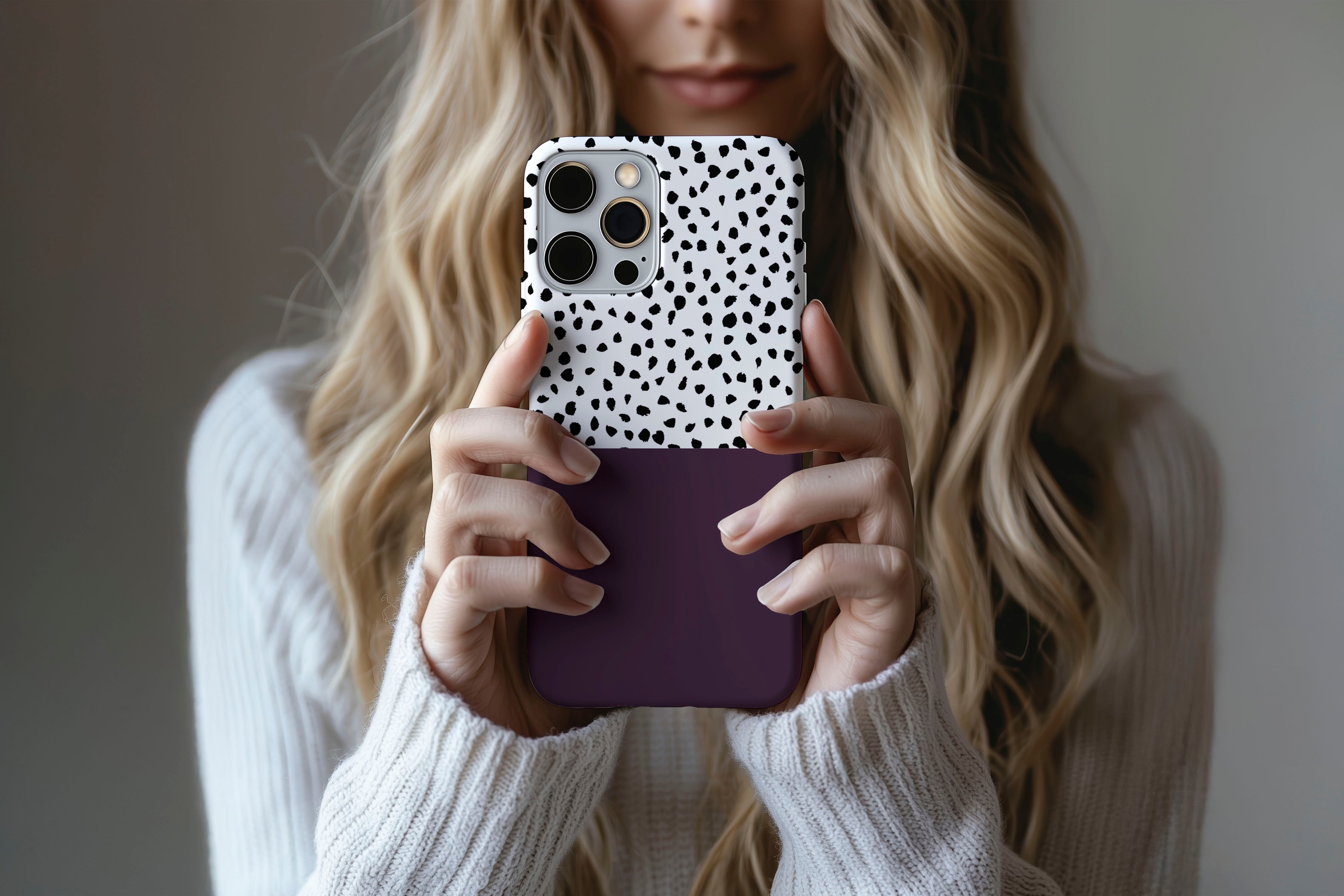 Lifestyle image of Geo Dots (Black Cherry) phone case showing geometric dots print design