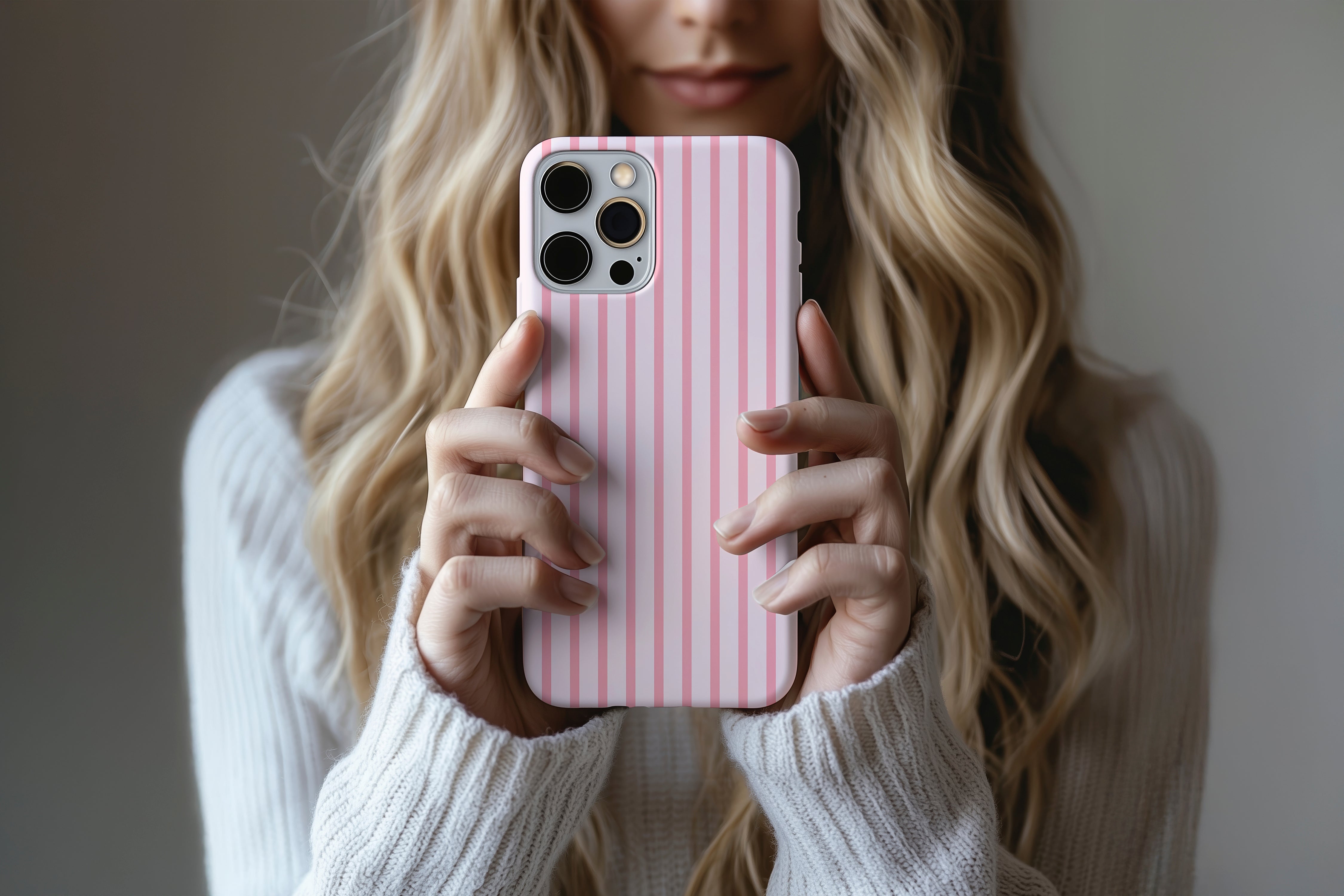 Lifestyle image of Sleepover Pink Stripe phone case showing soft pink stripe design