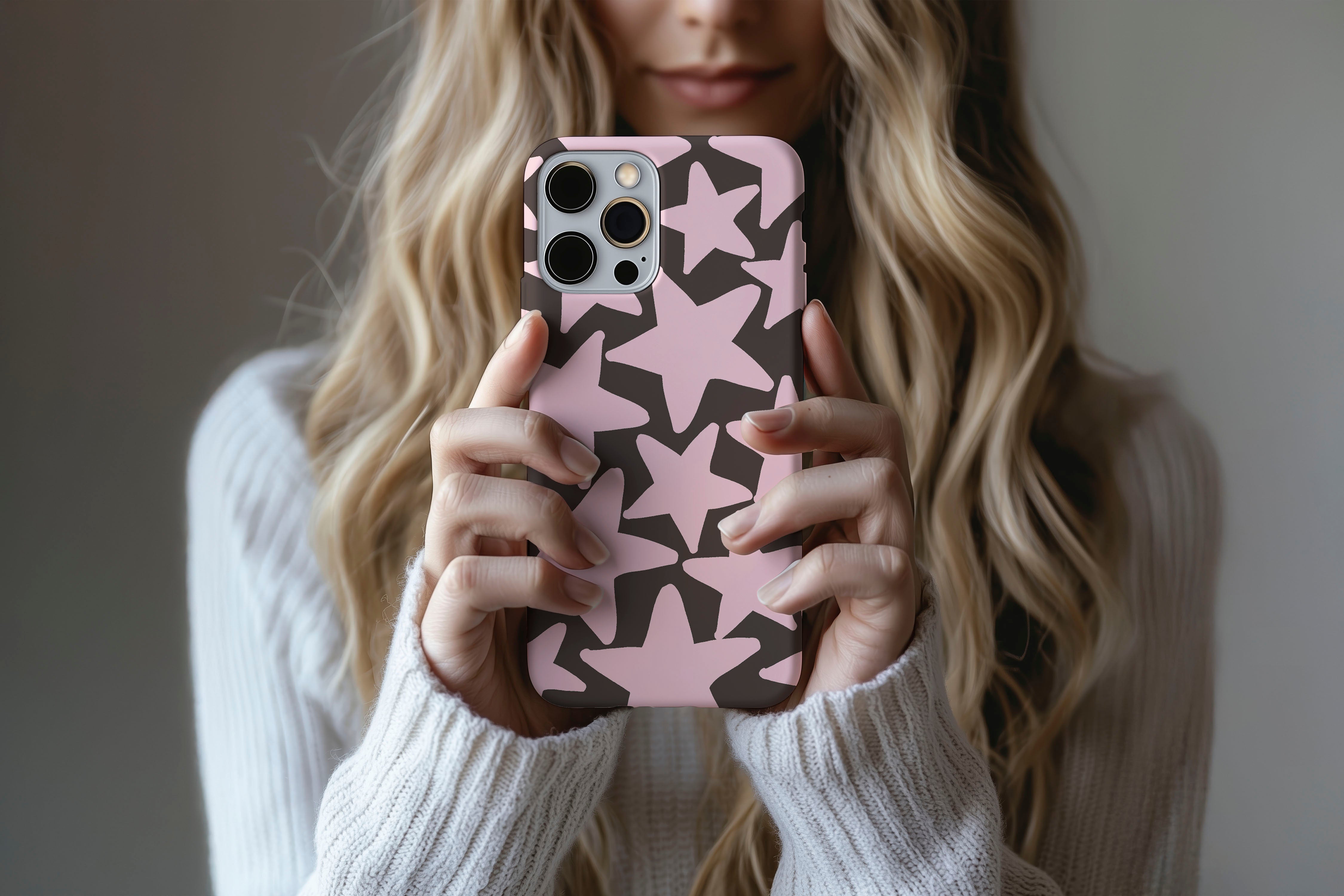 Lifestyle image of Stars (Pink) phone case showing star print design