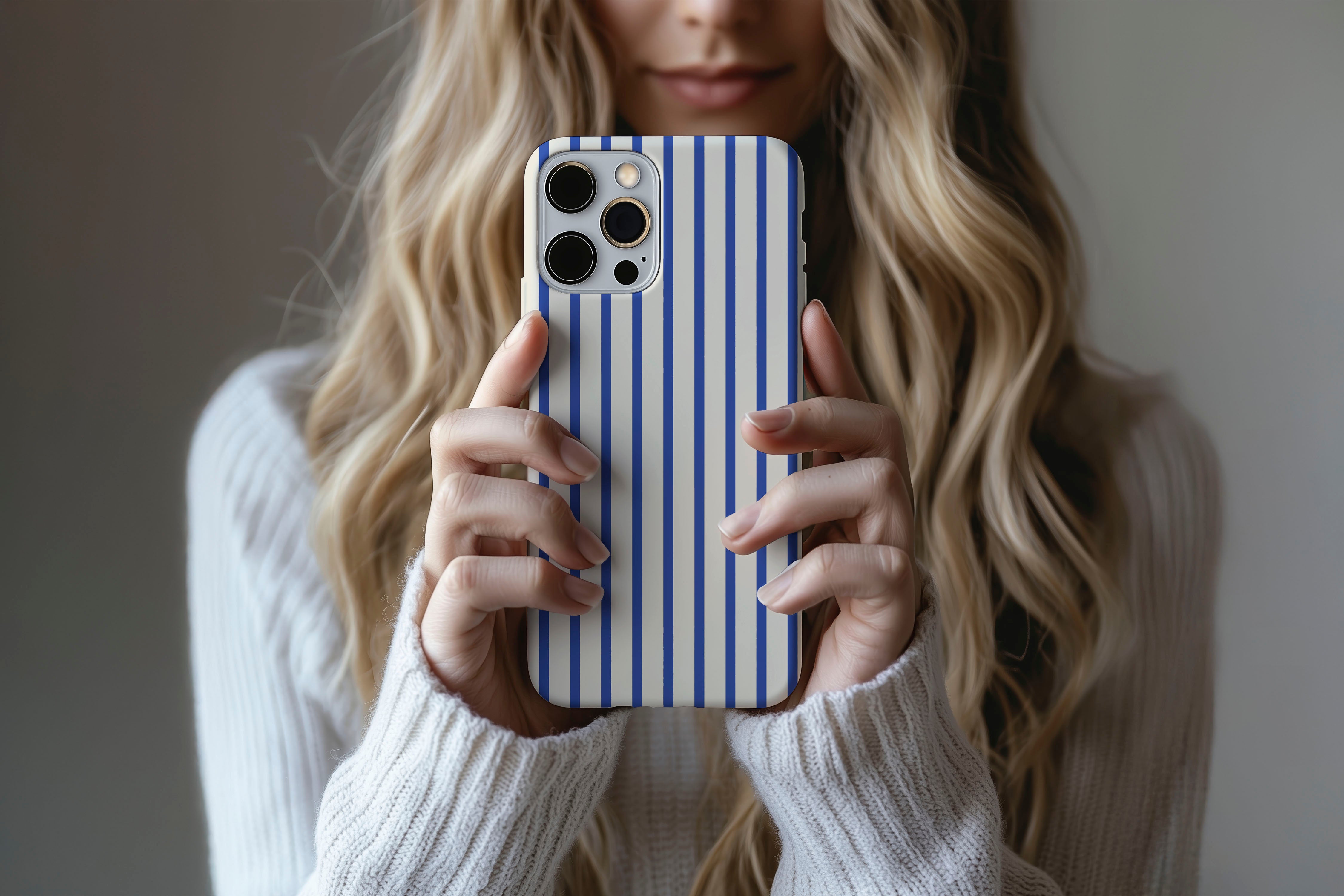 Lifestyle image of Stripes Cobalt phone case showing stipes design