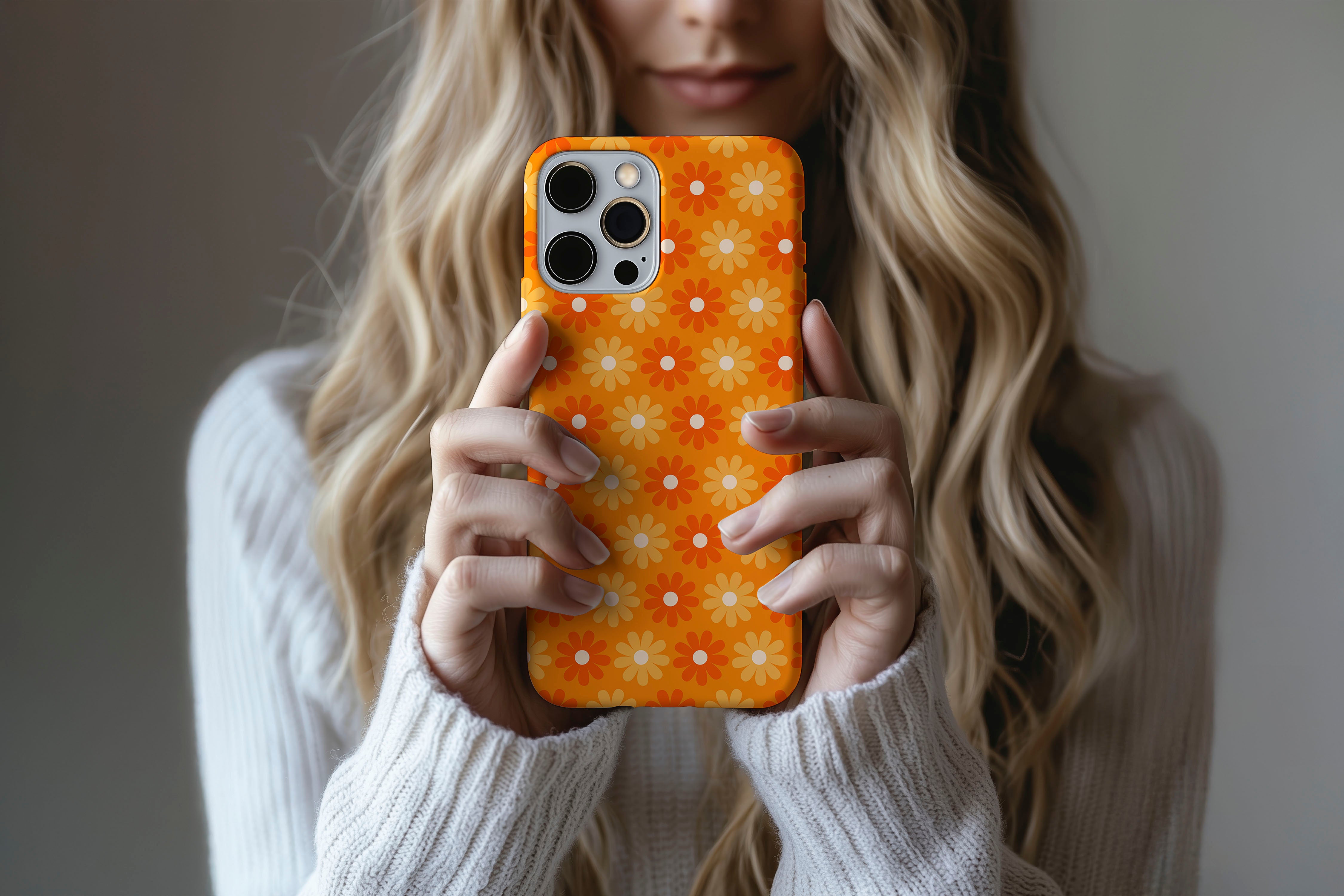 Lifestyle image of Sunlit Daisies phone case showing floral print design