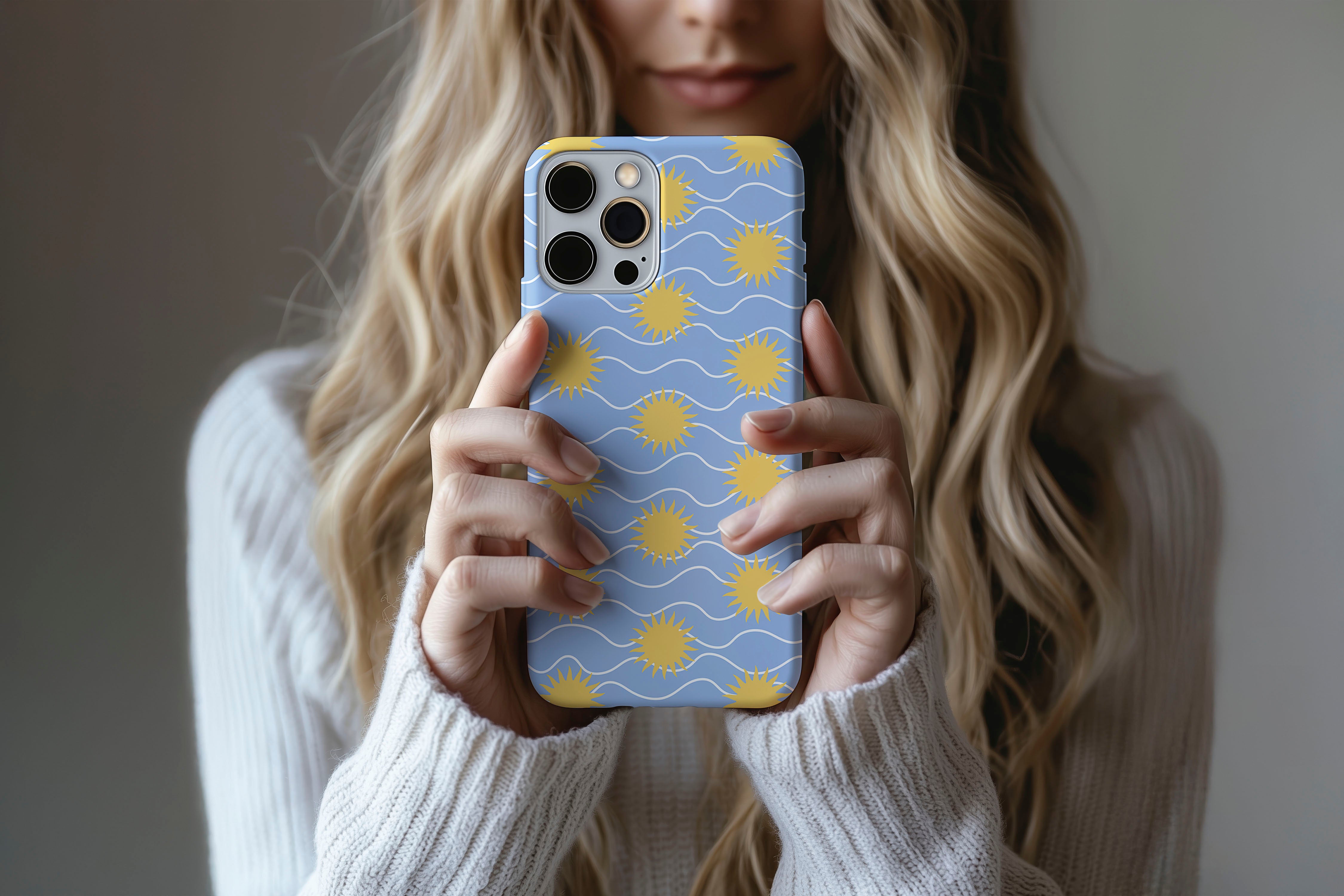 Lifestyle image of Sunstroke phone case showing sun print design