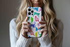 Lifestyle image of Abstract Cats phone case showing multi colour cat print design 