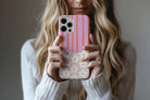 Lifestyle image of Cabana Bloom phone case showing striped floral print design
