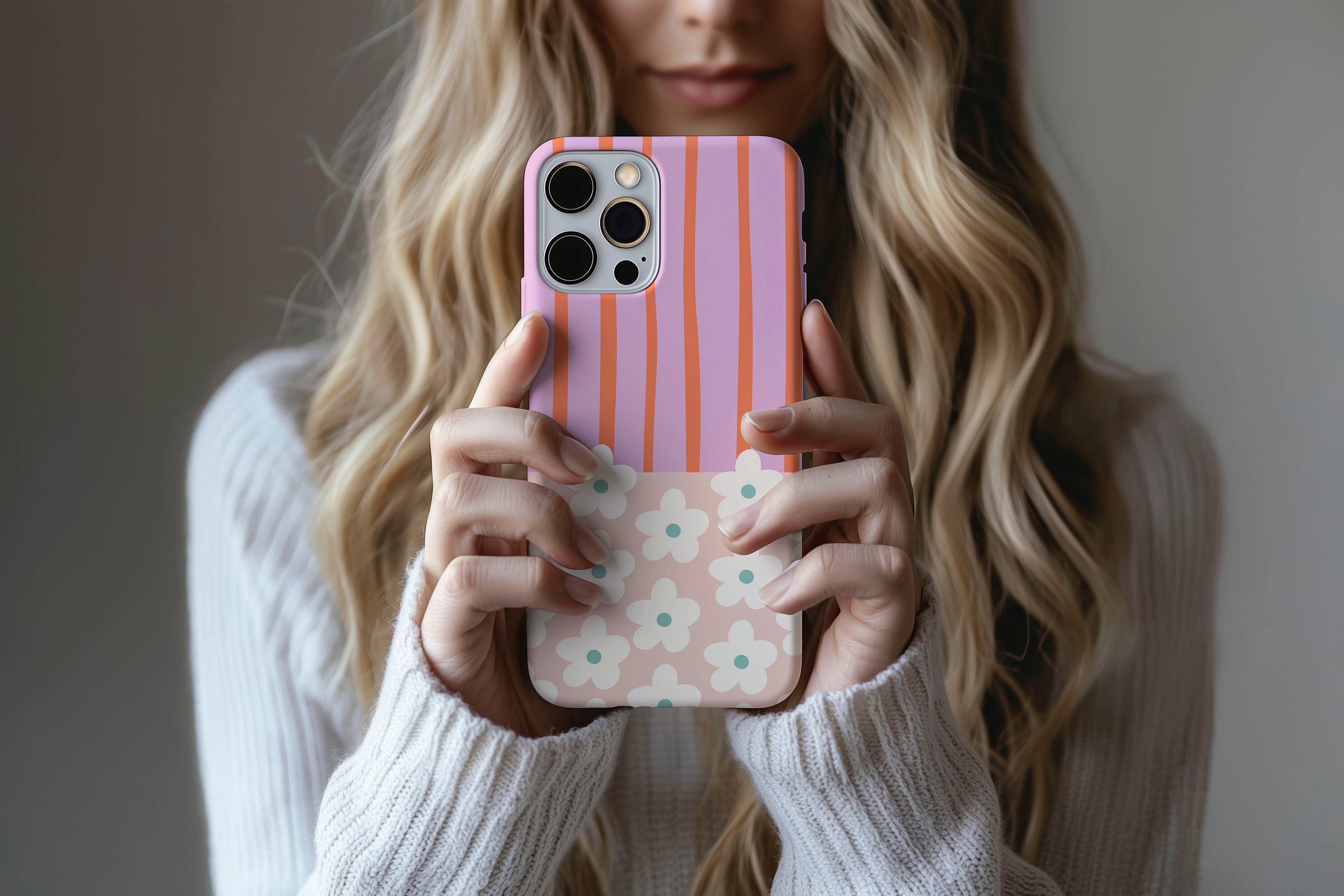 Lifestyle image of Cabana Bloom phone case showing striped floral print design