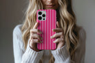 Lifestyle image of Candy Stripe phone case showing  pink stripe design 