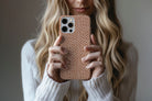 Lifestyle image of Caramel Dots phone case showing dotty design 