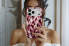 Lifestyle image of Confetti (Berry) MagTough phone case showing berry, blush pink and cream confetti glass print