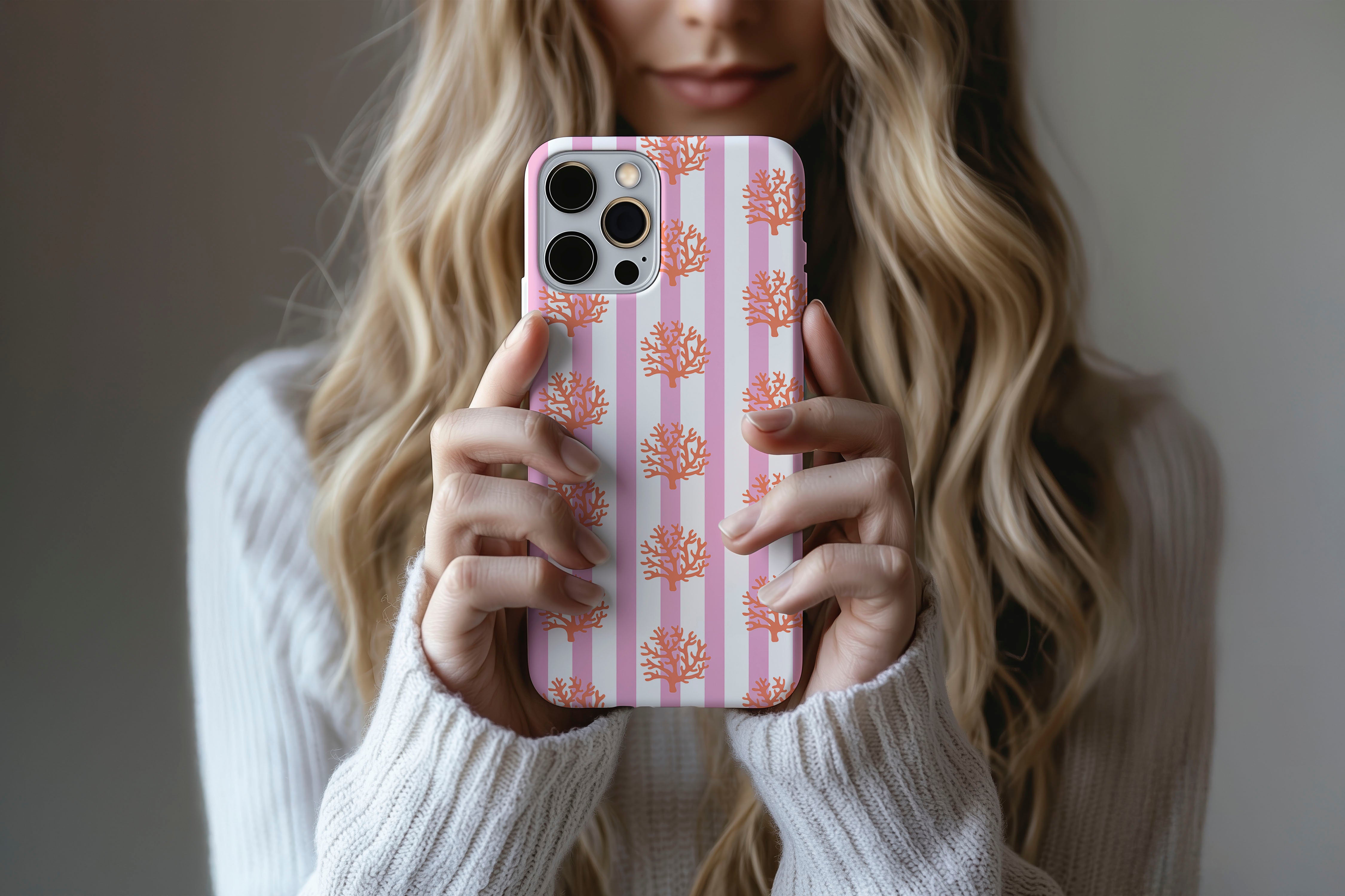 Lifestyle image of Coral phone case showing orange corals print design