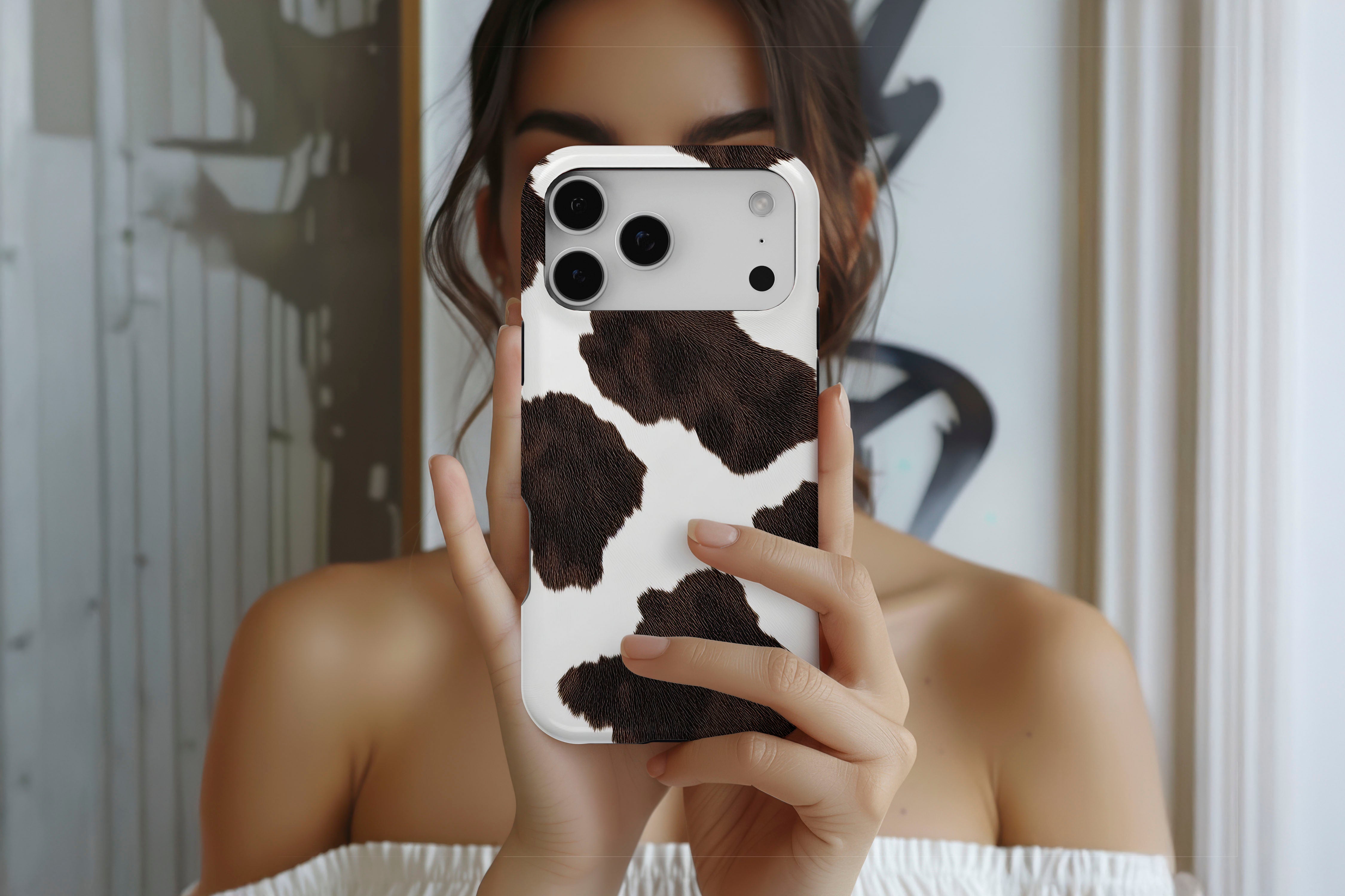 Lifestyle image of Cowhide magnetic tough case showing cow print design