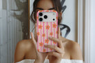 Lifestyle image of Daisy Chain magnetic tough case showing daisy stripe print design