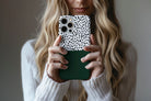 Lifestyle image of Geo Dots (Green) phone case showing geometric dots print design