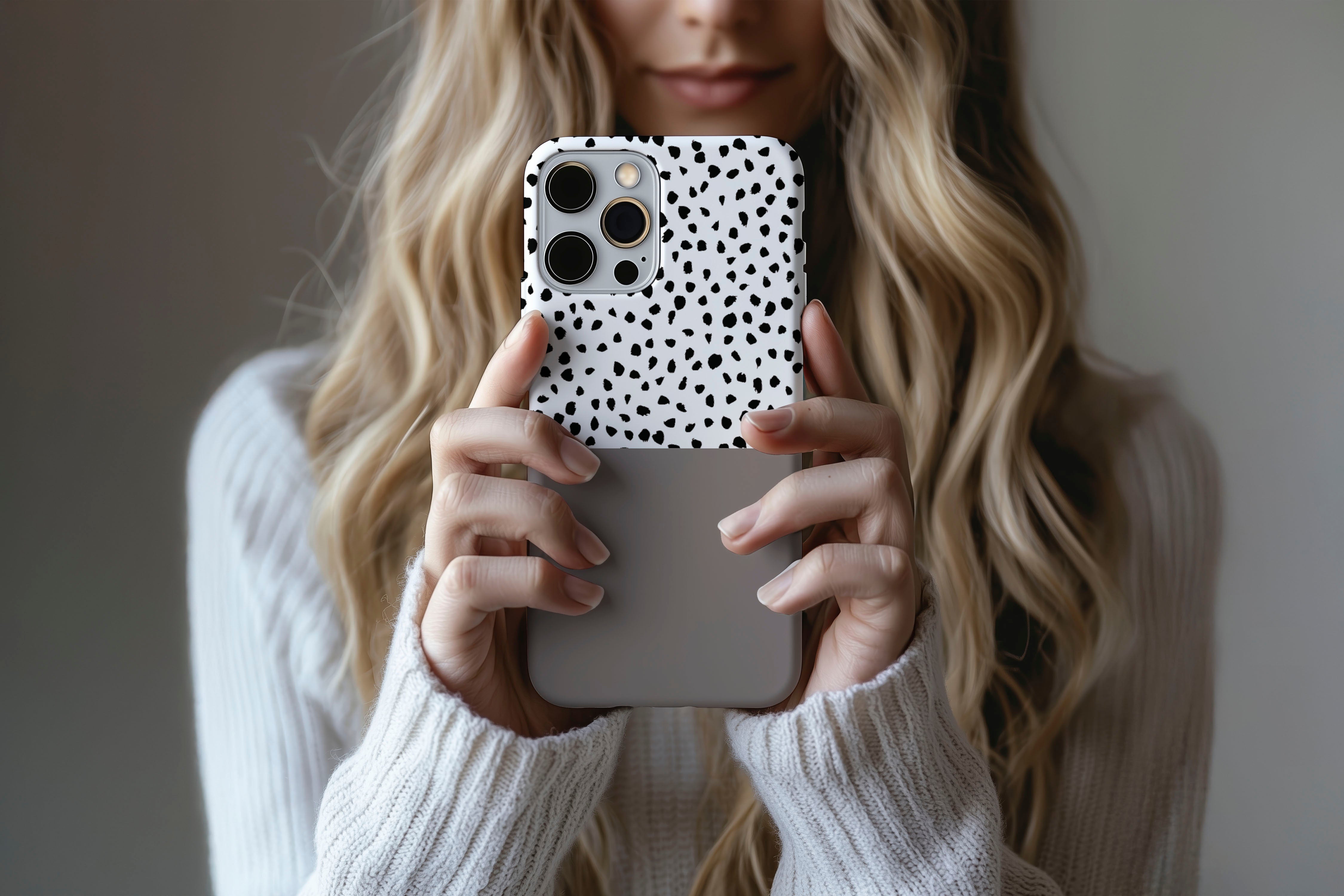 Lifestyle image of Geo Dots (Latte) phone case showing geometric dots print design