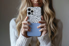 Lifestyle image of Geo Dots (Light Blue) phone case showing geometric dots print design