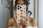 Lifestyle image of Harvest Pop magnetic tough case showing pumpkin print design