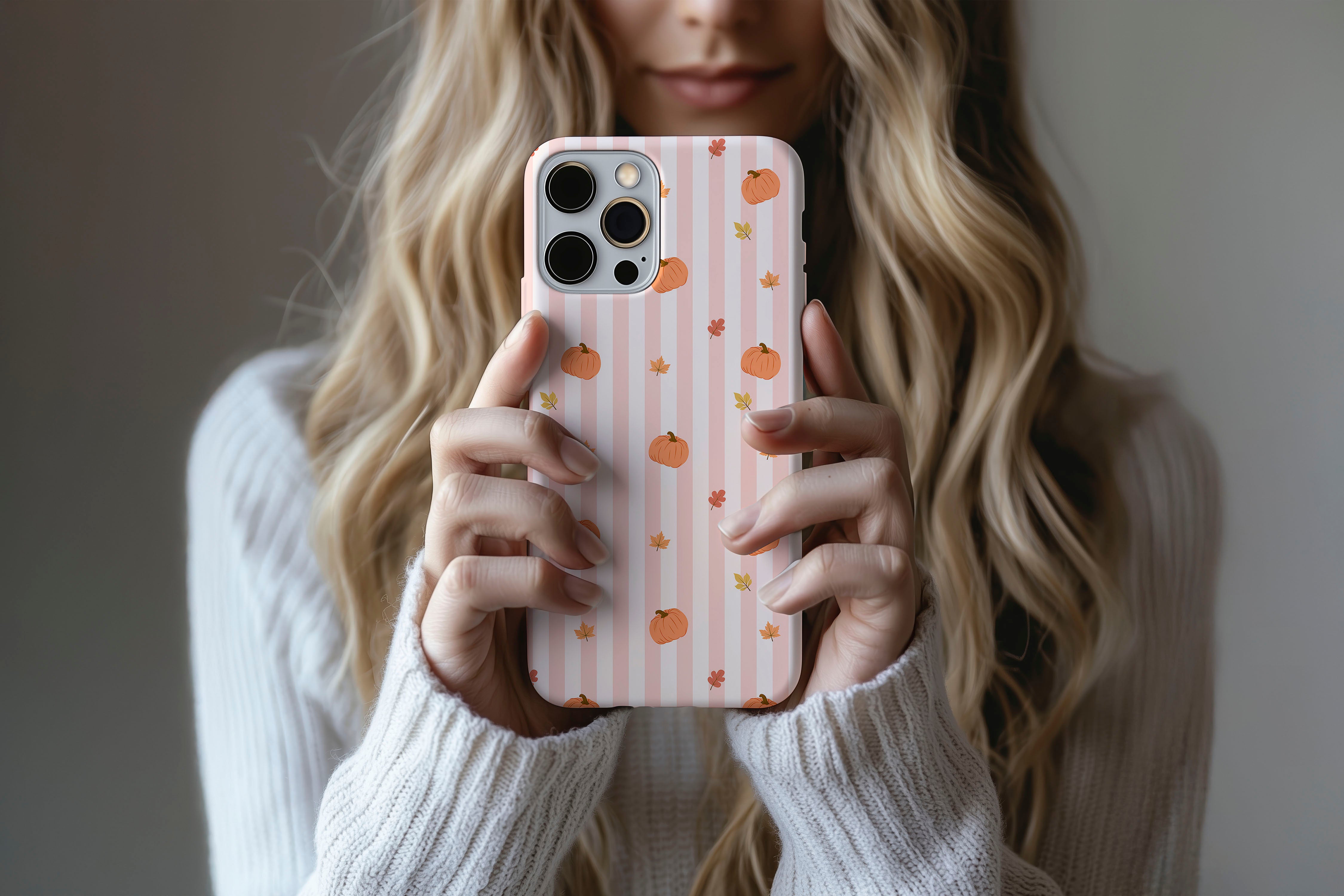 Lifestyle image of Hey There Pumpkin phone case showing pumpkin stripe print design