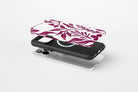 Side view of Matisse (Burgundy) phone case showing burgundy botanical line print on a cream base