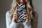 Lifestyle image of Mono Zebra phone case showing zebra print design