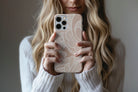 Lifestyle image of Nude Lace phone case showing lace print design 