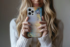 Lifestyle image of Opulent Marble phone case showing marble print design