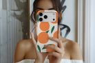 Lifestyle image of Oranges magnetic tough case showing orange fruity design 