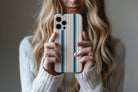 Lifestyle image of Palm Springs phone case showing multi stripe print design