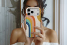 Lifestyle image of Rainbow Sun magnetic tough case showing multicolour rainbow design 
