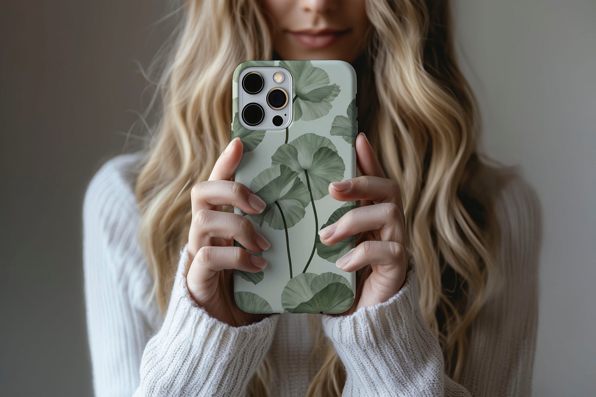 Lifestyle image of Sage Botanica phone case showing soft sage and eucalyptus green botanical floral print