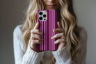 Lifestyle image of Soho phone case showing rich burgundy and pink vertical stripe print