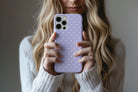 Lifestyle image of Spotted Lilac phone case showing dotty design 