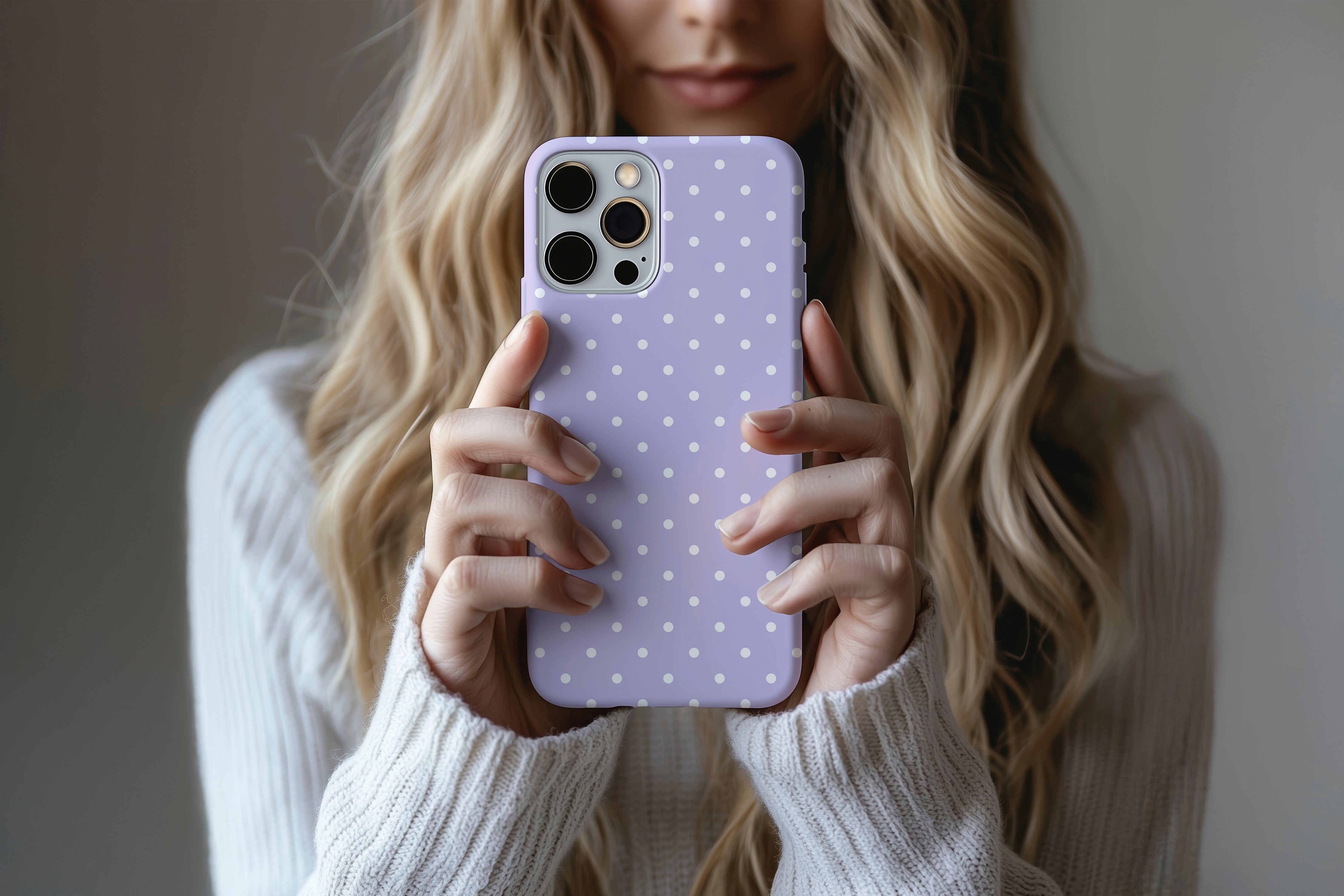Lifestyle image of Spotted Lilac phone case showing dotty design 