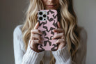 Lifestyle image of Stars (Pink) phone case showing star print design