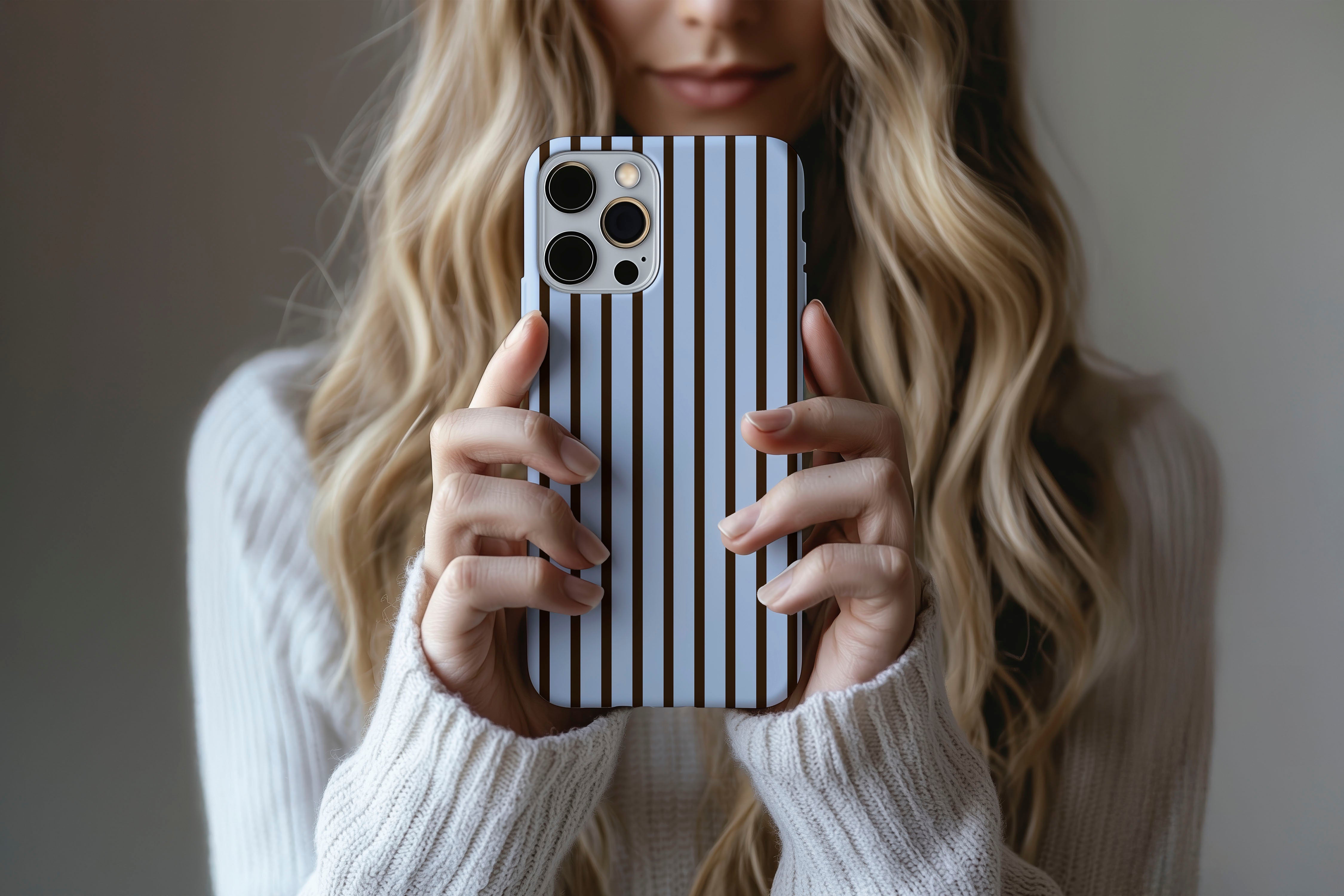Lifestyle image of Stripes (Blue Mocha) phone case showing stripe print design