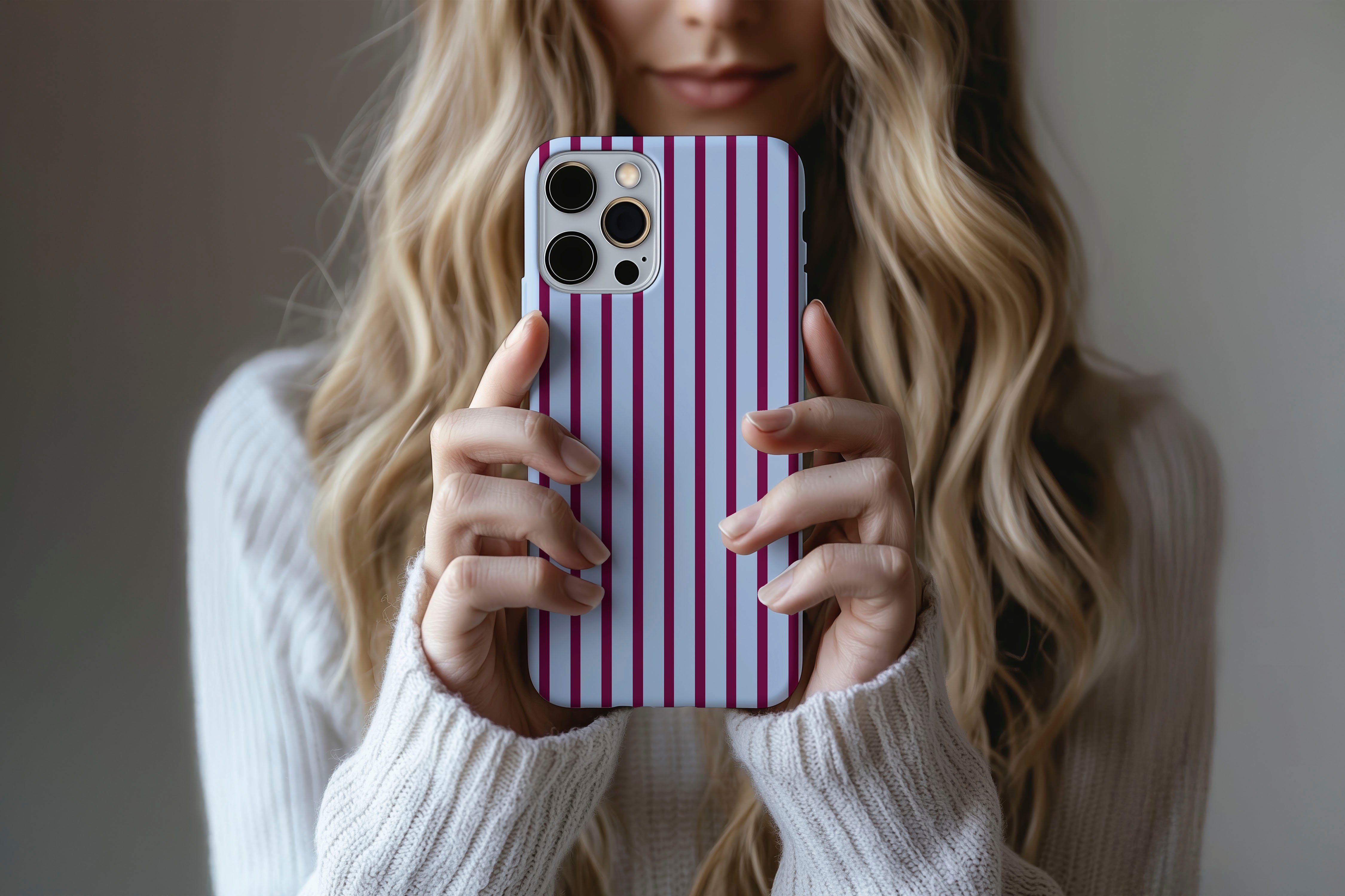 Lifestyle image of Stripes (Burgundy) phone case showing stripe print design