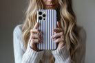 Lifestyle image of Stripes Cobalt phone case showing stipes design 
