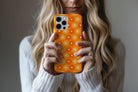 Lifestyle image of Sunlit Daisies phone case showing floral print design