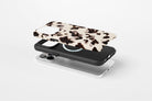 Side view of Vanilla Shell phone case showing cool cream tortoiseshell-inspired print with deep espresso brown markings